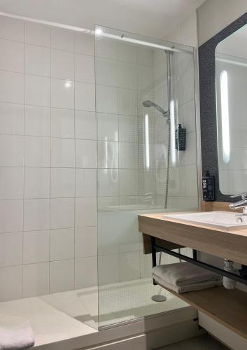 a bathroom with a shower and a sink at Ibis Angoulême Nord in Champniers