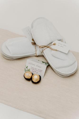 a pair of white flip flops sitting on a table at Waterfall Lodge in Carool