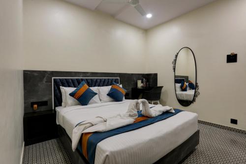 a bedroom with a large bed and a mirror at DIAMOND HOTEL in Mumbai
