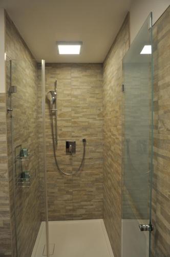 a bathroom with a shower with a glass door at Ferienwohnung Bärbel in Sautens