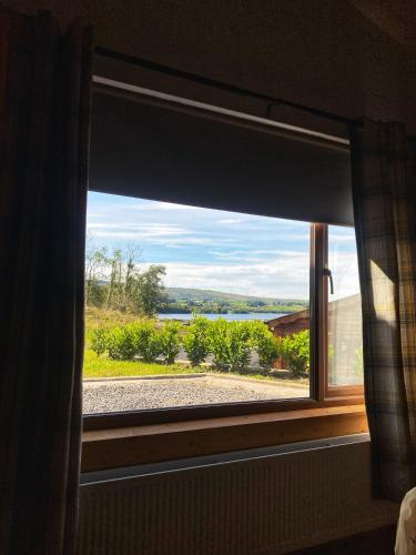 a window in a room with a view of a field at Dulrush Self-Catering Lodges in Belleek