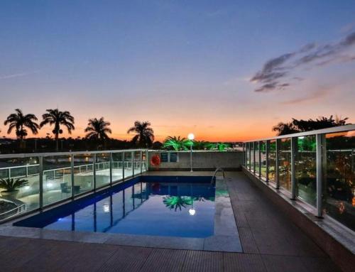 a swimming pool on the roof of a building at Suites Pampulha Hotel in Belo Horizonte