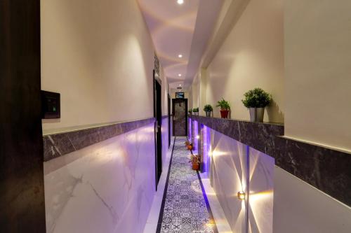 a hallway with purple lights on the wall at DIAMOND HOTEL in Mumbai