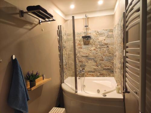 a bathroom with a shower and a tub and a sink at il Rifugio del Marinaio in Genova