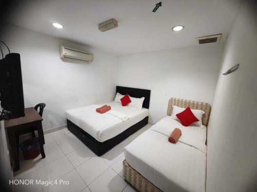 a room with two beds and a couch in it at Melawati Ria Hotel in Kuala Selangor