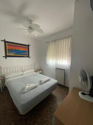 a bedroom with a bed with two towels on it at Hostal Milmarcos in Zaragoza