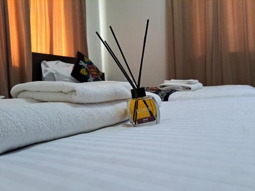 a bottle of essential oils on a bed with towels at Ocean hotel in Osh