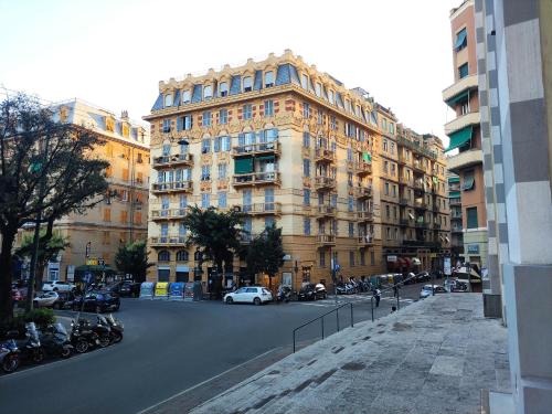 a large building with cars parked in front of a street at il Rifugio del Marinaio in Genova