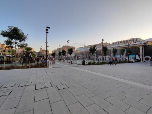 a plaza in a city with people walking and buildings at il Rifugio del Marinaio in Genova