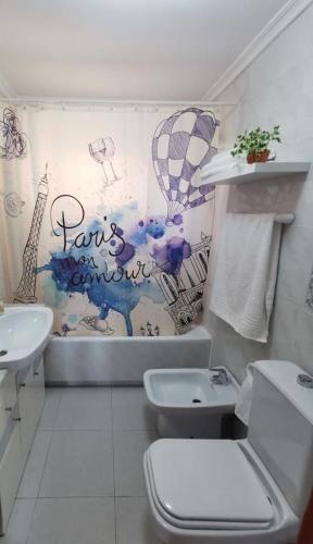 a bathroom with a white toilet and a sink at Dune Beach in Arenales del Sol