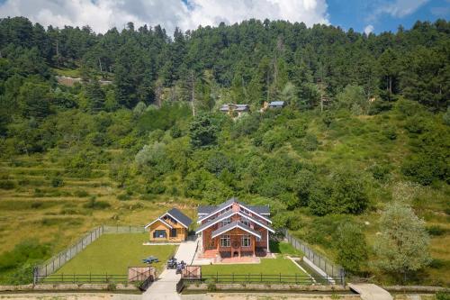 an aerial view of a house on a hill at StayVista at Suroor with Central Heating in Tangmarg in Tangmarg