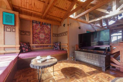a large living room with a large flat screen tv at StayVista at Suroor with Central Heating in Tangmarg in Tangmarg