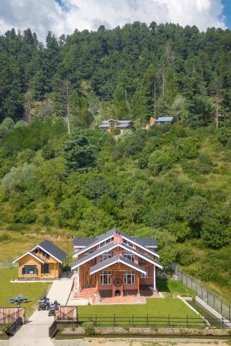 a large house on top of a hill at StayVista at Suroor with Central Heating in Tangmarg in Tangmarg