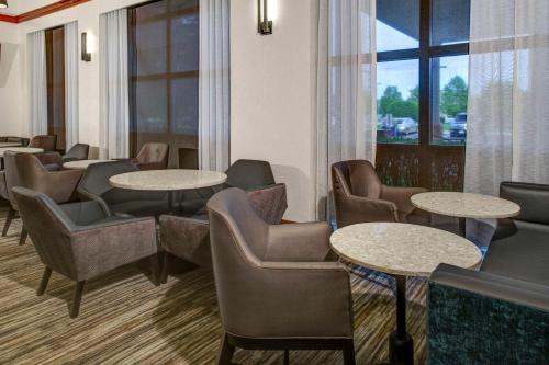 a waiting room with tables and chairs and a window at Hyatt Place Nashville Brentwood in Brentwood
