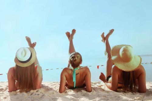 a group of girls sitting on the beach at Hilton Dead Sea Resort & Spa in Sowayma