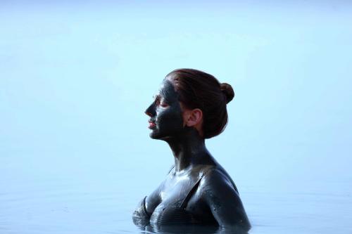 a statue of a woman sitting in the water at Hilton Dead Sea Resort & Spa in Sowayma