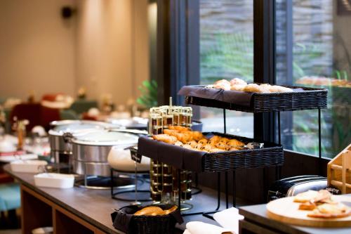 a buffet line with trays of pastries on display at Le Grand Hôtel Grenoble, BW Premier Collection by Best Western in Grenoble