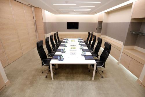 a conference room with a long table and chairs at Hilton Dead Sea Resort & Spa in Sowayma