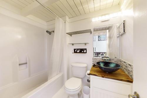 a bathroom with a sink and a toilet and a tub at Sunrise Serenity at Tahoe Village in Stateline