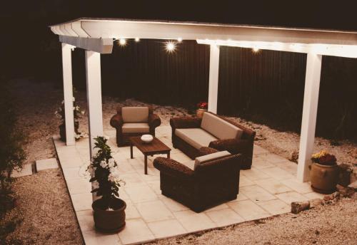 a gazebo with chairs and a couch and a table at Relais I Secolari in Selva di Fasano