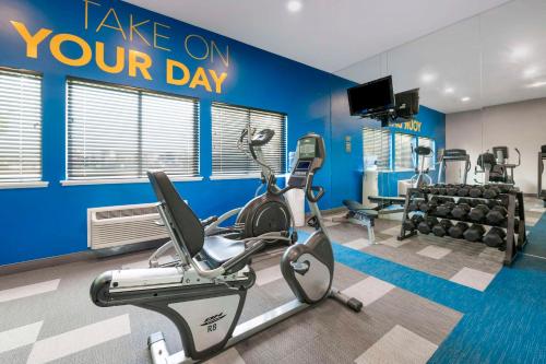 a gym with cardio equipment and a sign that reads take on your day at Comfort Inn Edinburgh - Columbus in Edinburgh