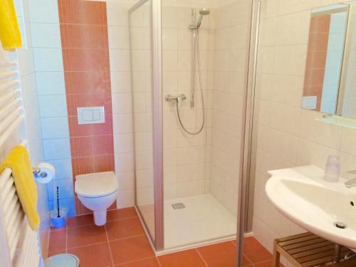 a bathroom with a shower and a toilet and a sink at Sunny Villa in Bad Kleinkirchheim
