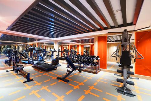 a gym with treadmills and cardio equipment in a building at Ramada Encore Al Khobar Corniche in Al Khobar
