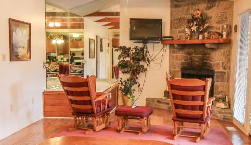 uma sala de estar com uma mesa e cadeiras e uma lareira em Mountain Dew - 2 Bedrooms, 2 Baths, Sleeps 4 cabin em Gatlinburg