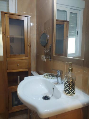 a bathroom with a white sink and a mirror at Victoria Stay Terraza Vistas y Garaje incluido in Alcalá la Real