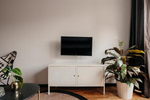 a living room with a tv on a white cabinet at TSA Sepulveda in Barcelona