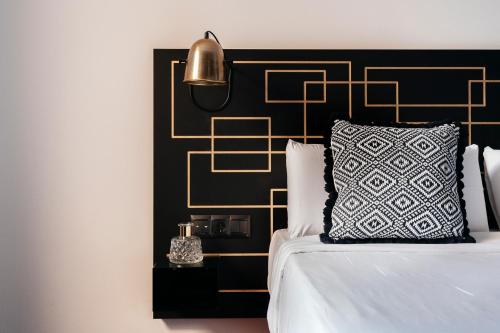 a bedroom with a bed with a black and gold headboard at TSA Sepulveda in Barcelona