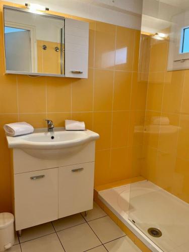a bathroom with a sink and a shower at Hôtel Les Sables - Urban Style - by Logis Hotels in Canet-en-Roussillon