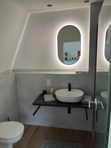 a bathroom with a sink and a toilet and a mirror at Moseltürmchen Cochem in Cochem