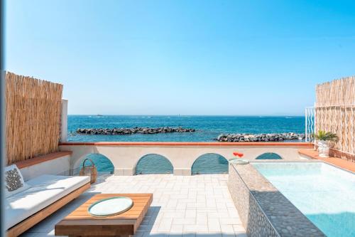 a patio with a swimming pool and the ocean at Villa Buon Gesu' in Massa Lubrense