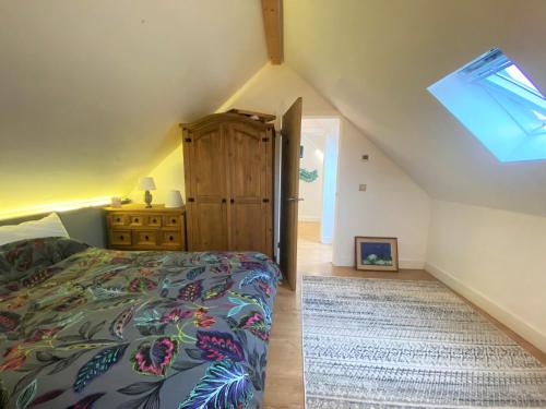 a attic bedroom with a bed and a skylight at Contemporary Eco-Home near Bristol Harbourside in Bristol