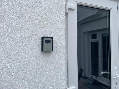 a black object on the side of a building at Carbis Bay Suite, Carbis Bay, St Ives, free parking, near beach in Carbis Bay