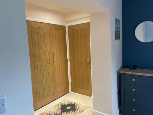a hallway with two wooden doors in a room at Carbis Bay Suite, Carbis Bay, St Ives, free parking, near beach in Carbis Bay
