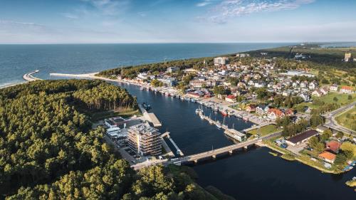 an aerial view of a town on the water at Lighthouse, Sun & Snow in Mrzeżyno