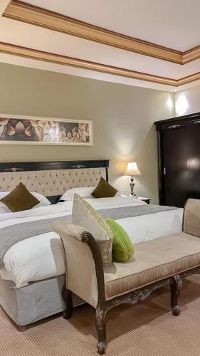 a hotel room with two beds and a couch at Levant Hotel in Najran