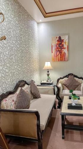 a living room with a bed and a couch at Levant Hotel فندق قصر المشرق in Najran