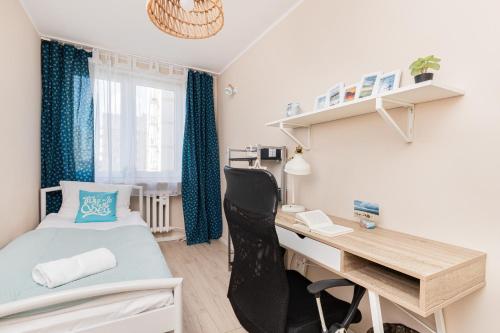 a small room with a desk and a bed and a desk and chair at Apartament Dlugie Ogrody Gdansk Downtown by Renters in Gdańsk