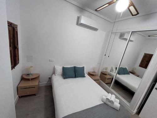 ein Schlafzimmer mit einem großen weißen Bett und einem Spiegel in der Unterkunft Nice flat in Gran Via CB-GRAC-18B in Madrid