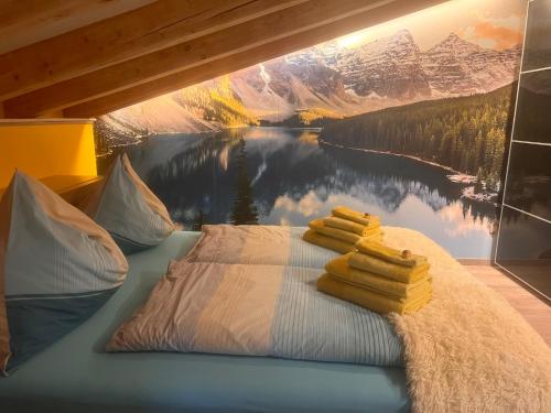 a bedroom with a painting of a lake and mountains at Apartment Villa Sonnegg in Fulpmes