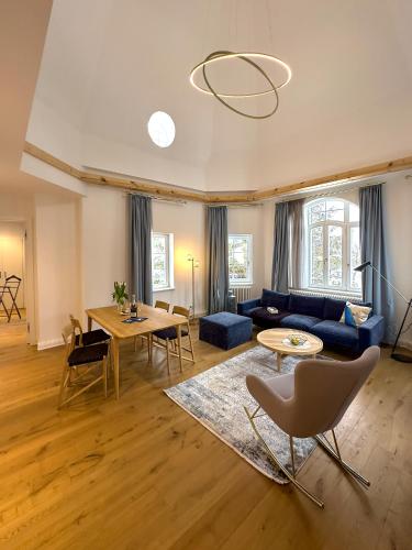 a living room with a couch and a table at Pineblue Villas in Heringsdorf