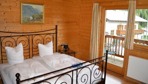 a bedroom with a bed and a balcony at Alexandra Alber Villa Schlosskopf in Sankt Anton am Arlberg
