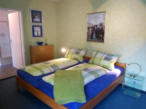 a bedroom with two beds and a picture on the wall at Fata Morgana in Cochem