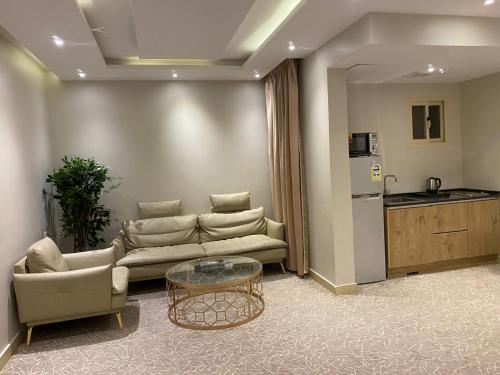 a living room with a couch and a table at سكناي صلاح الدين in Hail