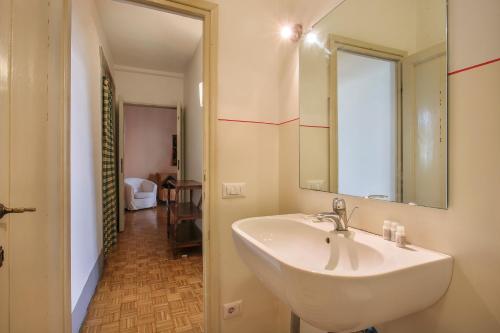 a bathroom with a white sink and a mirror at Lemon Tree One Bedroom with Balcony in Florence