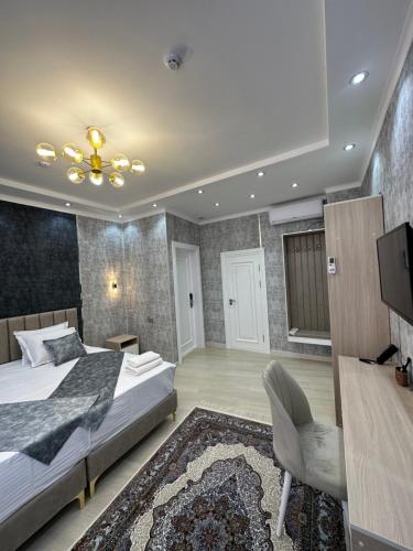 a bedroom with a bed and a flat screen tv at New Minor Hotel in Khiva