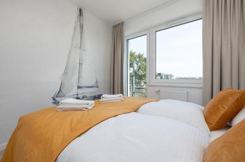 Ένα ή περισσότερα κρεβάτια σε δωμάτιο στο Seaside Apartamenty Bałtycka 22 Kołobrzeg, parking w cenie